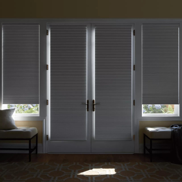 French doors with Duette Cellular Shades blocking the light outside. 